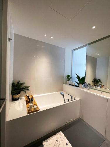 a bathroom with a tub and a large mirror at Veranda Residence Hua-Hin in Hua Hin
