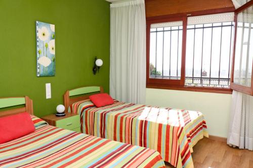 En eller flere senge i et værelse på Chalet Grecia Inmomart