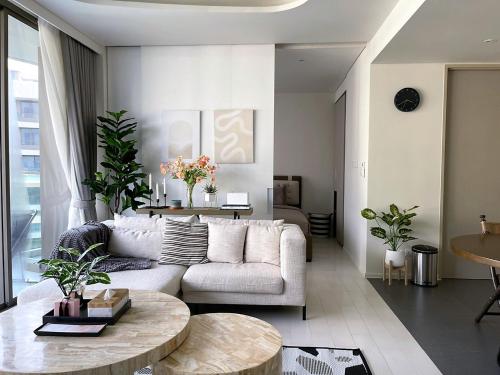 a living room with a couch and a table at Veranda Residence Hua-Hin in Hua Hin