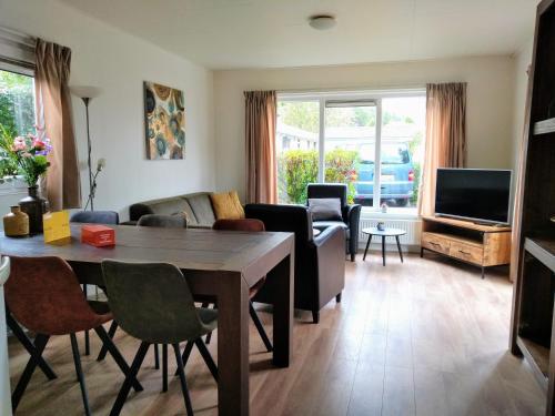 a living room with a table and a couch at Holiday rentals in Velsen-Zuid