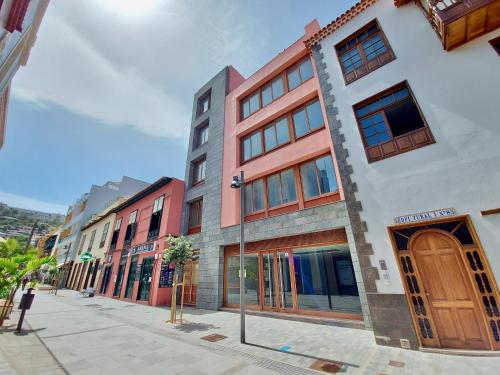a row of buildings on a city street at Aromas Suites Apartments in Puerto de la Cruz