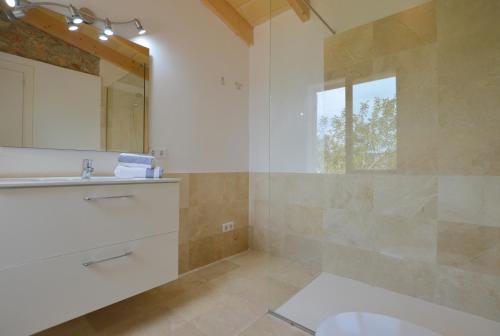 a bathroom with a toilet and a sink and a mirror at Alconasser 2 - Amazing Seaviews between Deia & Soller in Sóller