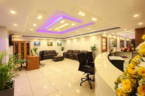 a lobby with a waiting room with chairs and a reception desk at Lumbini Supreme in Trichūr