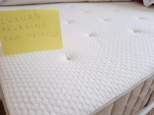 a sign sitting on top of a mattress at THE POPPIES Guest House - 100m Ocean - Private Spaces in Candelaria