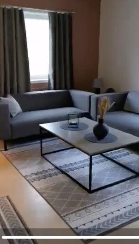 a living room with a couch and a coffee table at Kveldsol Apartments in Havøysund