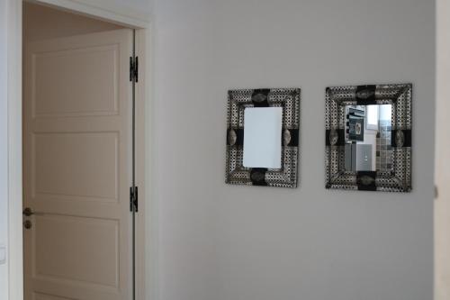 a mirror on the wall next to a door at Tiwaline Tarsime App E in Sidi Ifni