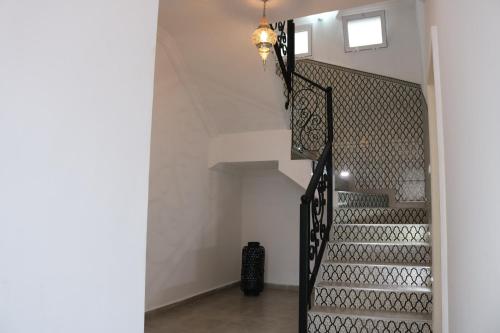 a staircase in a house with a chandelier at Tiwaline Tarsime App E in Sidi Ifni