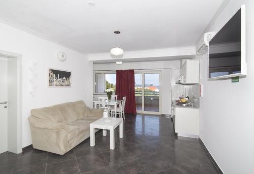 a living room with a couch and a table at Villa Antea Apartments with Free Parking in Dubrovnik
