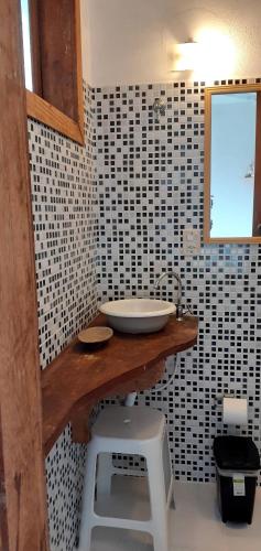 a bathroom with a sink and black and white tiles at Pousada Praia Verde in Imbituba