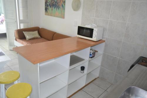 a kitchen with a counter with a microwave on it at Driftsands Sea View Flats in Uvongo Beach