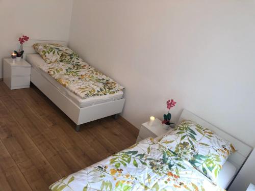 two beds in a small room with twoperate beds at Herrmann-Apartments in Hannover