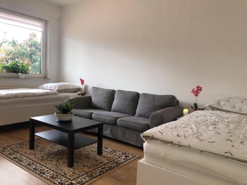 a living room with a couch and a coffee table at Herrmann-Apartments in Hannover