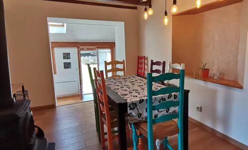 a dining room with a table and chairs in a room at Charmante maison de village à 50m de la plage in Excénevex