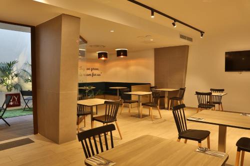 a restaurant with tables and chairs in a room at Ivy Hotel - Adults Only in St Julian's