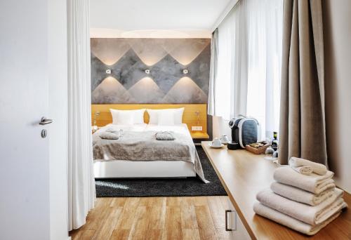 a bedroom with a bed and a large window at Seevital Hotel & SPA - Ihr 4 Sterne Superior Hideaway direkt am See in Langenargen