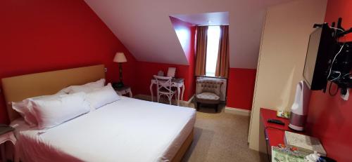 a bedroom with a white bed and red walls at Buccleuch and Queensberry Arms Hotel in Thornhill