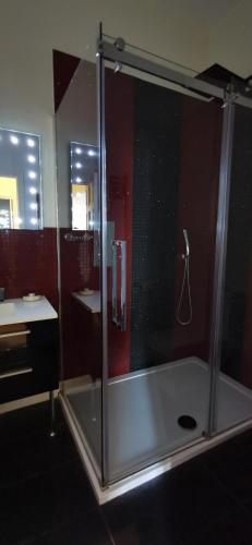 a shower with a glass door in a bathroom at Buccleuch and Queensberry Arms Hotel in Thornhill