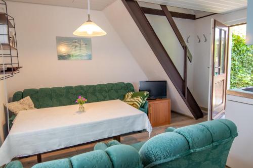 a living room with a couch and a table at Ferienhaus Boddenkieker in Freest
