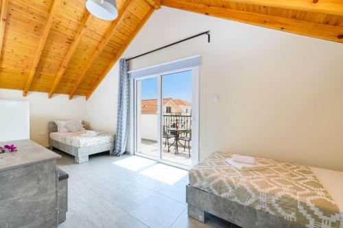 a bedroom with a bed and a balcony at Villa Olivia in Xylophaghou