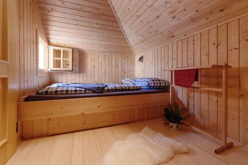 a room with two beds in a wooden cabin at Chalet Orlica Velika Planina in Stahovica