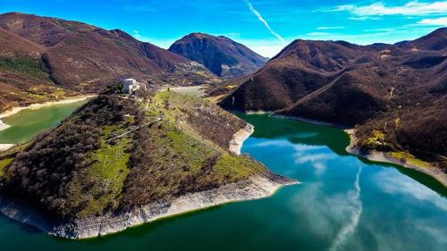 an island in the middle of a body of water at CASA CON TERRAZZI - 6posti 2stanze 2bagni - LAKEHOLIDAY IT in Castel di Tora