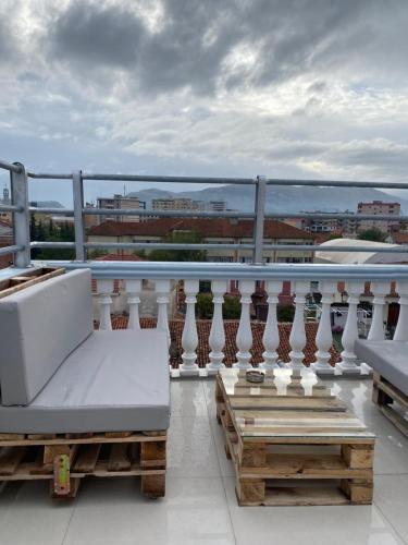a balcony with a white bench on a balcony at Eagle’s Nest in Shkodër