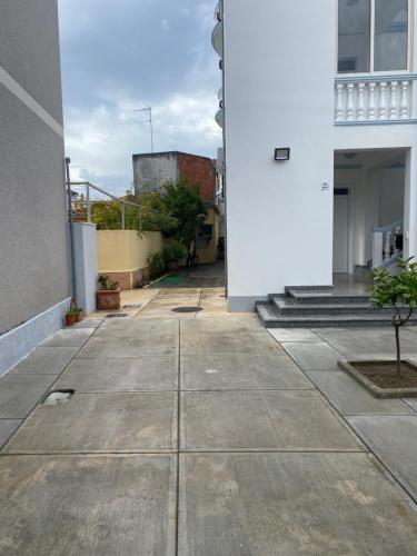 an empty sidewalk in front of a building at Eagle’s Nest in Shkodër