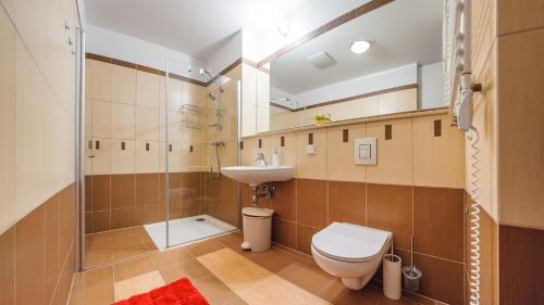 a bathroom with a toilet and a sink and a shower at Olympic Park I, Sun & Snow in Kołobrzeg