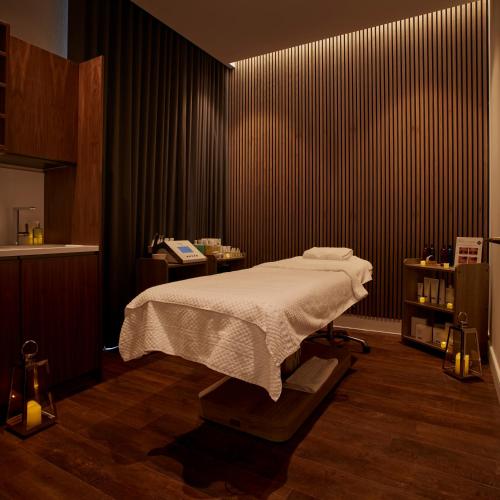 a bedroom with a bed and a black wall at The Parkgate Hotel in Cardiff