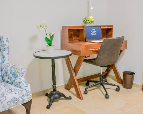 a desk with a laptop and a chair at Casa Mariano in Morelia