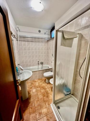 a bathroom with a shower and a toilet and a sink at Casa Fer La Morra in La Morra
