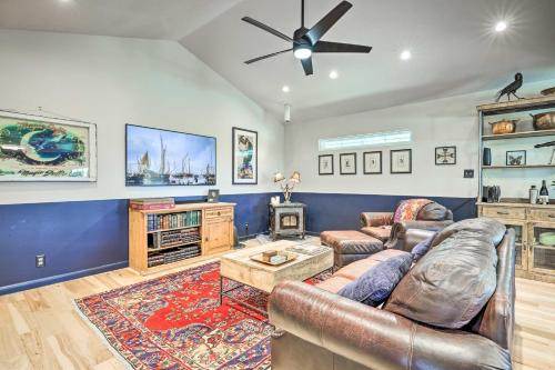 a living room with a couch and a ceiling fan at Dripping Springs Cabin with Pool, Hill Country Views in Dripping Springs