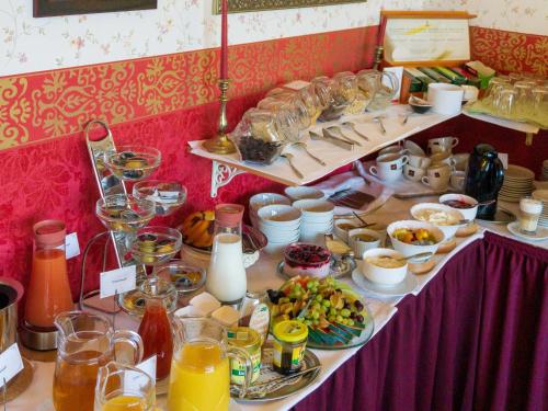 a table with a buffet of food and drinks at Schlossberg-Hotel Garni in Wernigerode