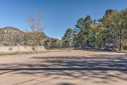 a car parked in a parking lot with a fence at Cabin with Mountain Views about 2 Mi to Ruidoso Midtown! in Ruidoso