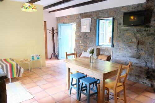 a dining room with a wooden table and chairs at Casa do Engenho - Canadelo Amarante in Amarante
