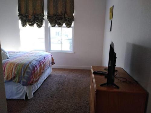 a bedroom with a bed and a tv on a dresser at Comfort and Style Queen bedroom in Vacaville