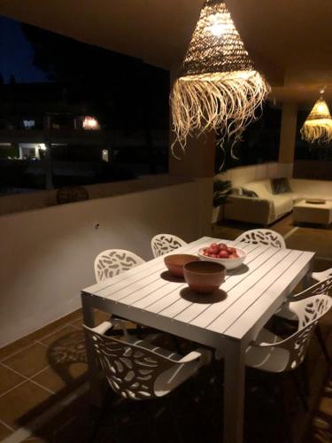 a small table with a bowl of fruit on it at Center beach 2 beds Appartement Elviria in Marbella
