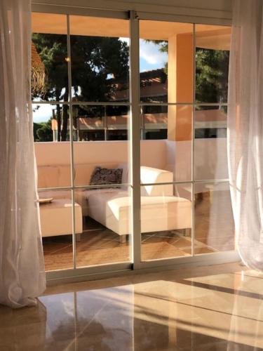 a view of a living room through a glass door at Center beach 2 beds Appartement Elviria in Marbella