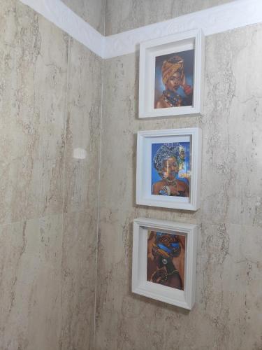 a group of four pictures hanging on a wall at Center beach 2 beds Appartement Elviria in Marbella
