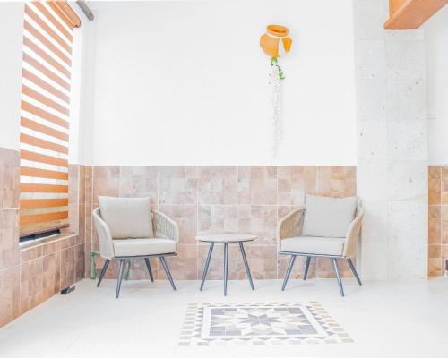 a patio with two chairs and a table at Casa Mariano in Morelia