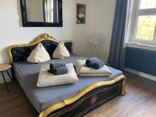 a bedroom with a bed with two pillows on it at Villa Schomberg in Spremberg
