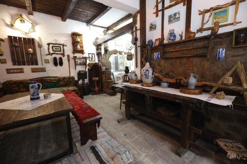 a living room with a couch and a table with vases at Etno kuća Teodora in Staji°evo