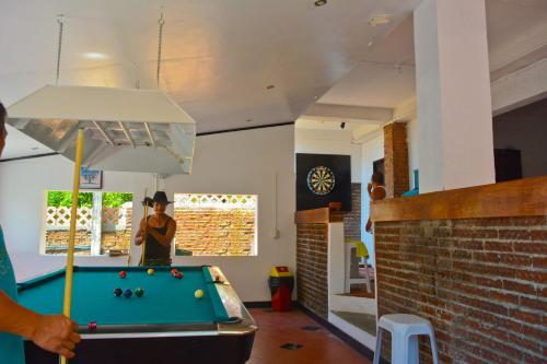 a man playing pool in a room with a pool table at Isla Bonita Beach Resort in San Juan