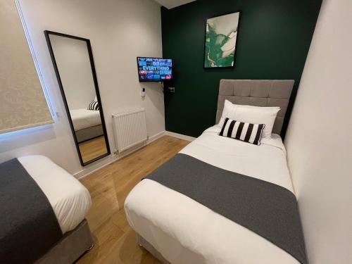 a hotel room with a bed and a television at Quay Apartments Manchester in Manchester