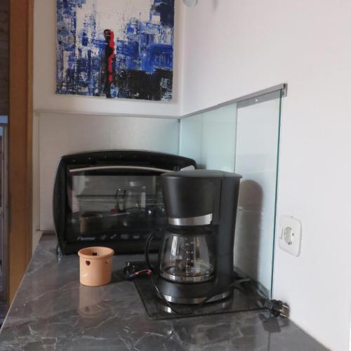 a coffee maker on a counter in a kitchen at Ferienwohnung Gouiaa in Bischofswiesen