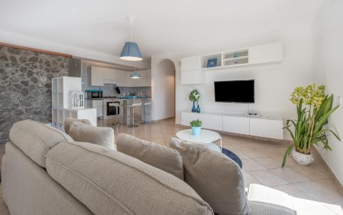 a living room with a couch and a kitchen at Villa Marianna in Massa Lubrense