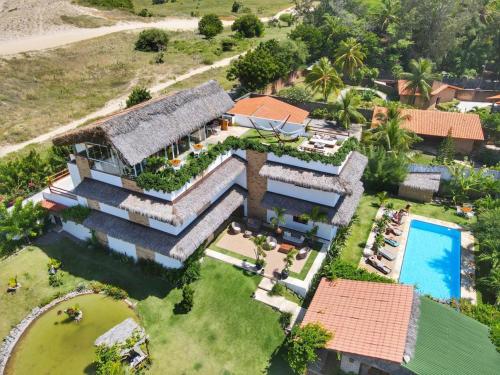 an aerial view of a house with a swimming pool at R.I.O in Cumbuco