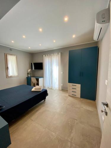a bedroom with a large bed and a blue cabinet at Floridida Rooms & Breakfast in Marina di Andora