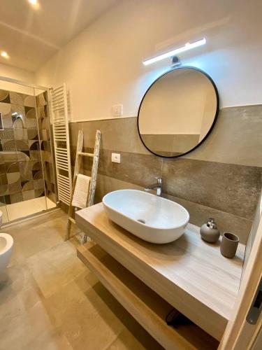 a bathroom with a sink and a mirror on a counter at Floridida Rooms & Breakfast in Marina di Andora