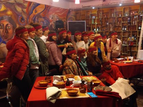 a group of people standing in a room with food at Telpochcalli Hotel & Temazcal in San Juan Teotihuacán
